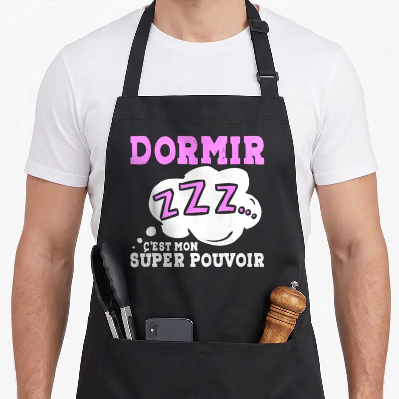 Tablier de cuisine noir avec inscription Dormir C'est Mon Super Pouvoir et bulle Zzz en rose et blanc.