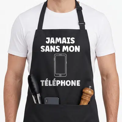 Tablier de cuisine noir avec l'inscription jamais sans mon téléphone et un dessin de smartphone blanc au centre.