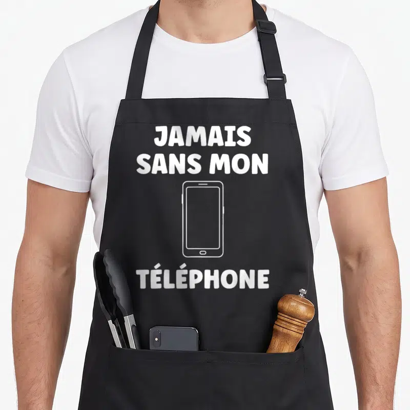 Tablier de cuisine noir avec l'inscription jamais sans mon téléphone et un dessin de smartphone blanc au centre.