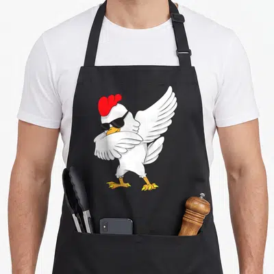 Tablier de cuisine noir avec une poule blanche en train de faire le dab avec des lunettes de soleil noires.