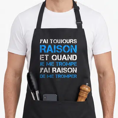 Tablier de cuisine noir avec le texte J'ai toujours raison et quand je me trompe en typographie blanche et bleue.