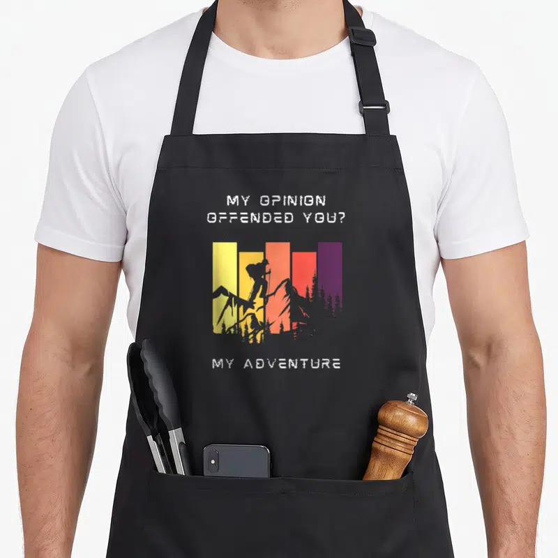 Tablier de cuisine noir avec silhouette de grimpeur sur fond de barres colorées et texte blanc.