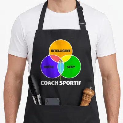 Tablier de cuisine noir avec un diagramme de Venn multicolore et le texte coach sportif en bas.