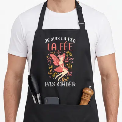 Tablier de cuisine noir avec une illustration de fée rose et le texte Je suis la fée la fée pas chier.