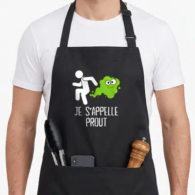 Tablier de cuisine noir avec silhouette blanche fuyant un nuage vert et le texte Je s'appelle Prout