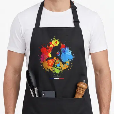 Tablier de cuisine noir avec silhouette de skateuse et éclaboussures de peinture multicolores en cercle.