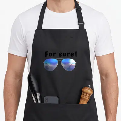 Tablier de cuisine noir orné d'une illustration de lunettes de soleil aviateur aux verres bleus irisés et du texte For sure.