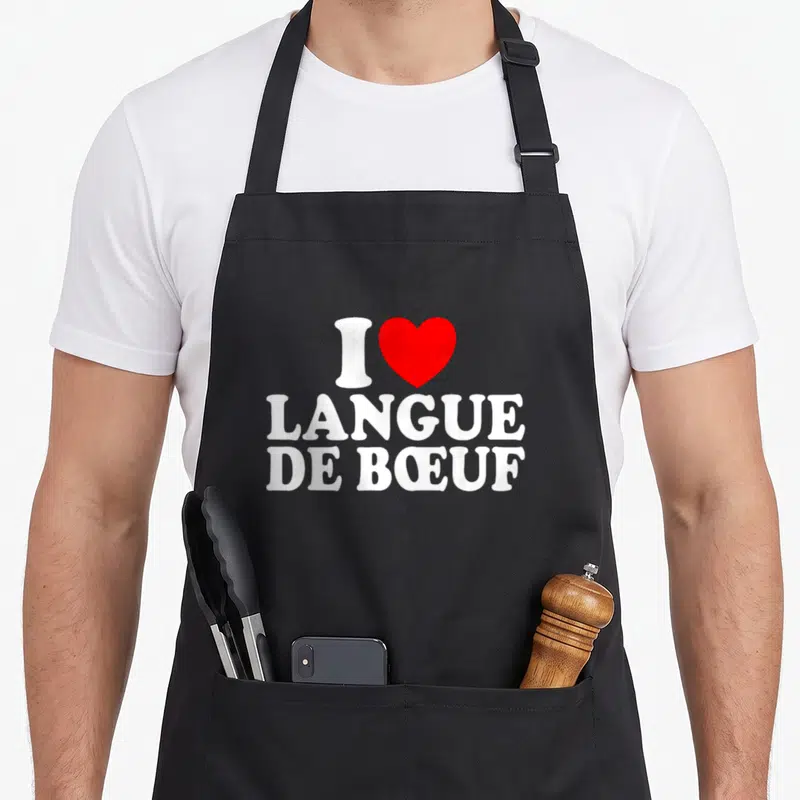 Tablier de cuisine noir avec inscription blanche I Love Langue De Boeuf et un cœur rouge central.