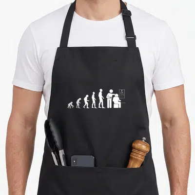 Tablier de cuisine noir avec silhouette blanche représentant l'évolution humaine se terminant par un examen d'opticien devant un tableau E.