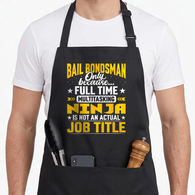 Tablier de cuisine noir avec inscription jaune et blanche Bail Bondsman Only because full time multitasking ninja is not an actual job title.