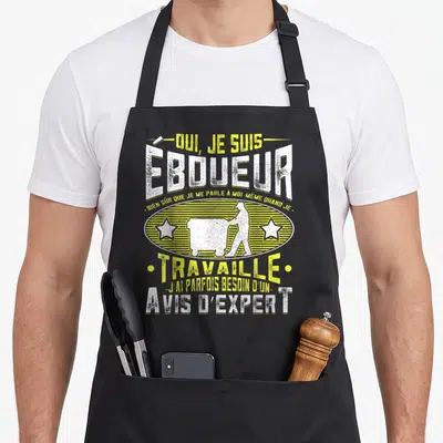 Tablier de cuisine noir avec inscription Oui je suis éboueur et silhouette d'un homme poussant une brouette entre deux étoiles jaunes.