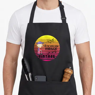 Tablier de cuisine noir avec illustration d'une femme vintage sur fond de soleil rayé coloré.
