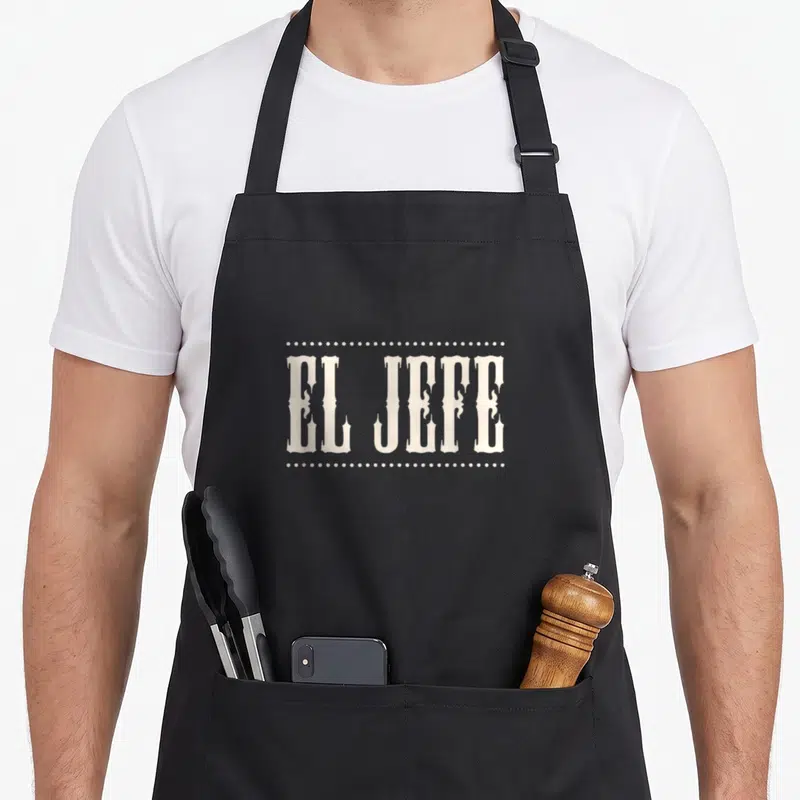 Tablier de cuisine noir avec inscription El Jefe en typographie style mexicain encadrée de points.
