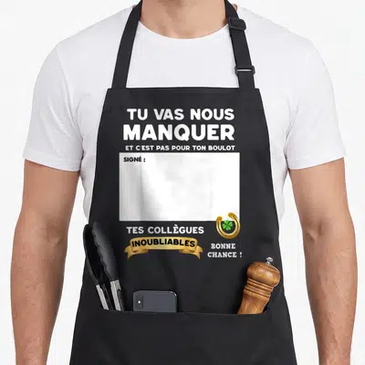 Tablier de cuisine noir avec le texte Tu vas nous manquer et c'est pas pour ton boulot signé par tes collègues inoubliables