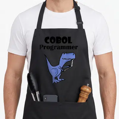 Tablier de cuisine noir avec un dinosaure bleu tenant une carte perforée et le texte COBOL Programmer.