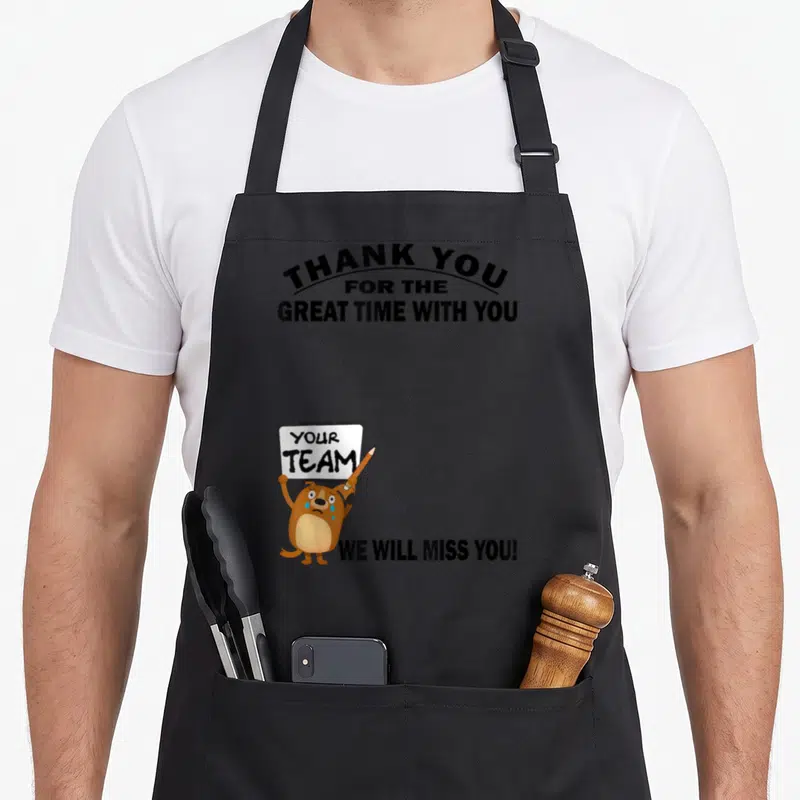 Tablier de cuisine noir avec un chien marron tenant une pancarte blanche et pleurant des larmes bleues.