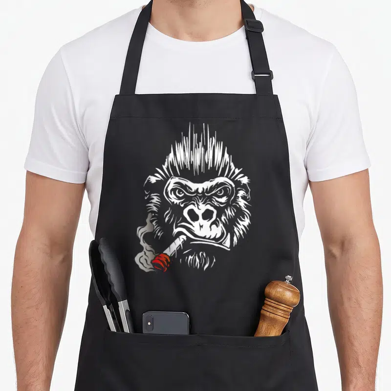 Tablier de cuisine noir avec illustration d'un gorille fumant une cigarette en style gravure blanche et grise.