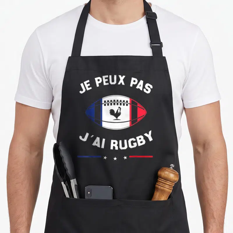 Tablier de cuisine noir avec ballon de rugby tricolore et texte blanc je peux pas j'ai rugby