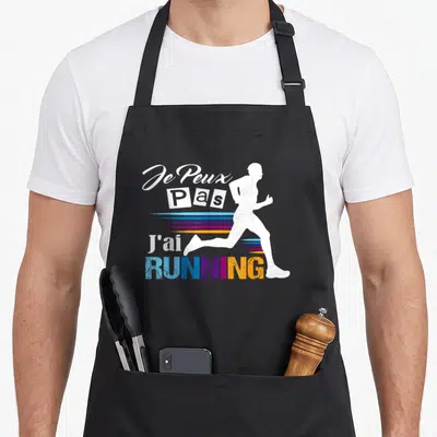 Tablier de cuisine noir avec silhouette de runner et texte Je Peux Pas J'ai Running multicolore.