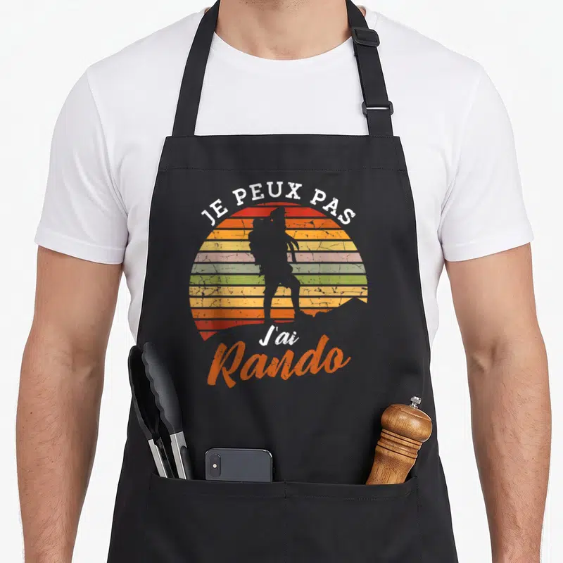 Tablier de cuisine noir avec silhouette de randonneur sur fond de soleil arc-en-ciel et texte je peux pas j'ai rando