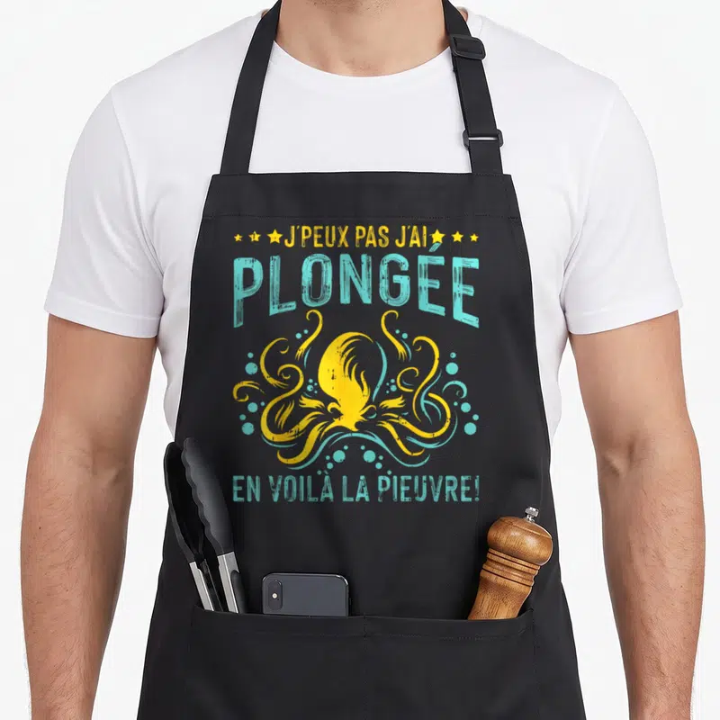 Tablier de cuisine noir avec une pieuvre jaune stylisée et le texte J'peux pas j'ai plongée la pieuvre en turquoise.