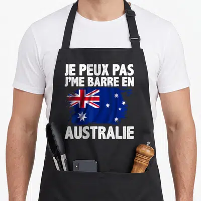 Tablier de cuisine noir avec texte blanc et drapeau australien stylisé au centre.