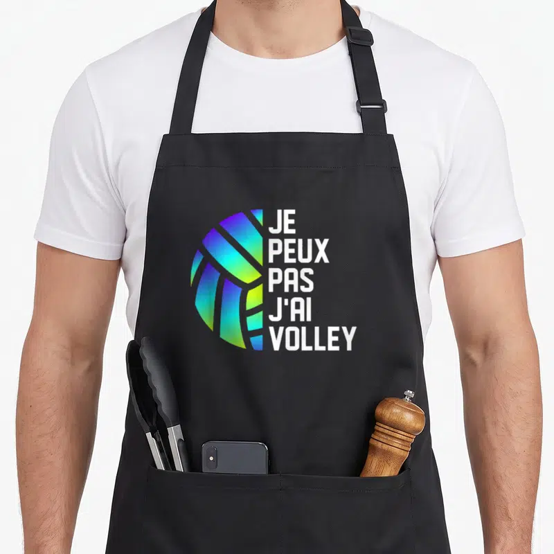 Tablier de cuisine noir avec un ballon aux couleurs dégradées et le texte je peux pas j'ai volley.
