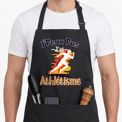 Tablier de cuisine noir avec silhouette de sprinteur blanc et texte J'Peux Pas J'ai Athlétisme en orange et violet.