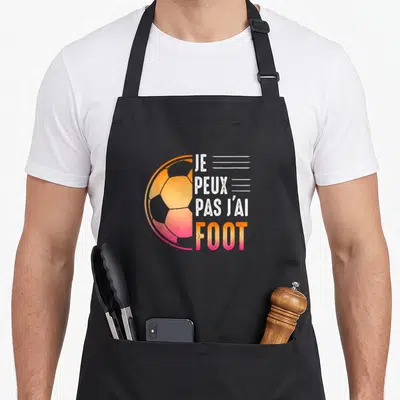 Tablier de cuisine noir avec motif football orange rose et texte je peux pas j'ai foot