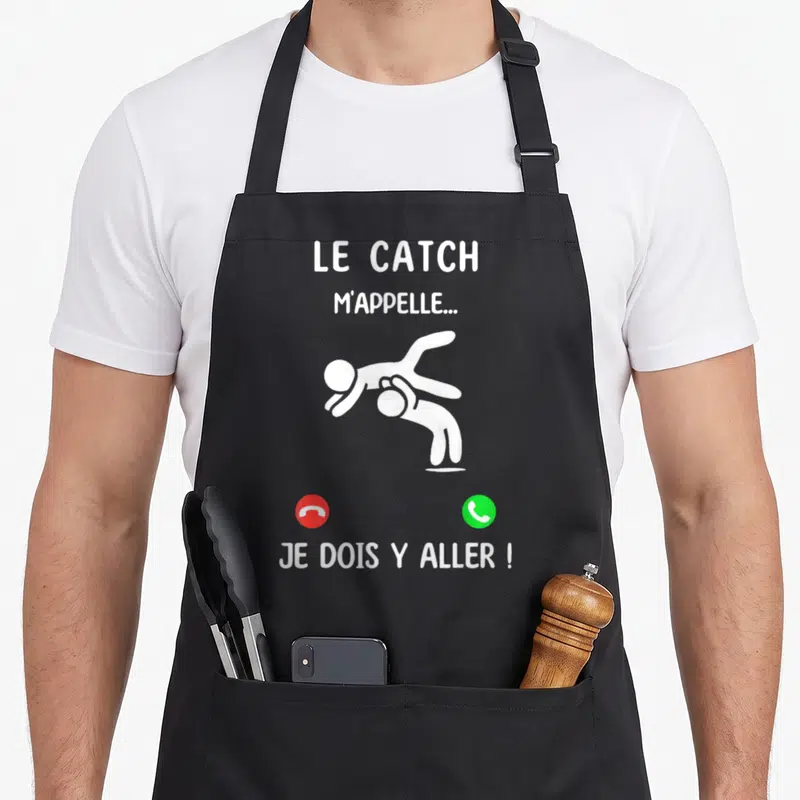 Tablier de cuisine noir avec une illustration blanche de catcheurs et des icônes de téléphone rouge et vert.