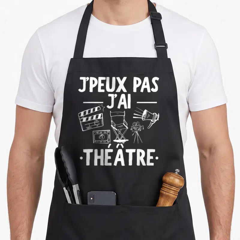 Tablier de cuisine noir avec inscription j'peux pas j'ai théâtre et équipements de filmage dessinés en blanc.