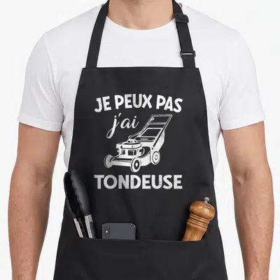 Tablier de cuisine noir avec inscription je peux pas j'ai tondeuse et dessin de machine à couper l'herbe en blanc