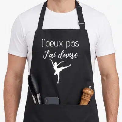 Tablier de cuisine noir avec inscription blanche J'peux pas J'ai danse et silhouette de ballerine en train de danser.