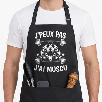 Tablier de cuisine noir avec illustration blanche d'un culturiste et texte J'peux pas j'ai muscu
