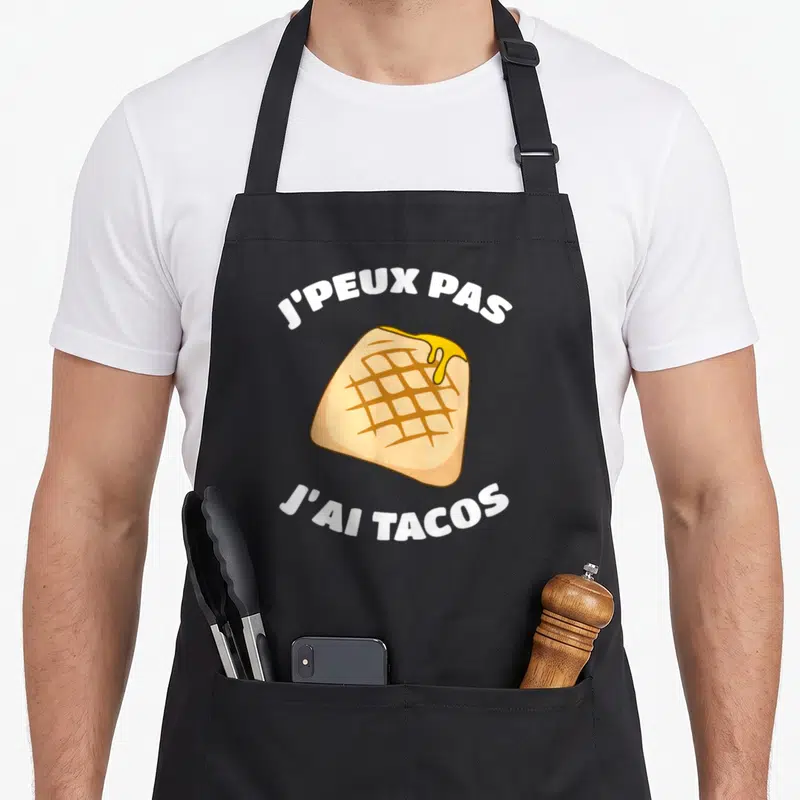 Tablier de cuisine noir avec illustration de taco et texte j'peux pas j'ai tacos en blanc.