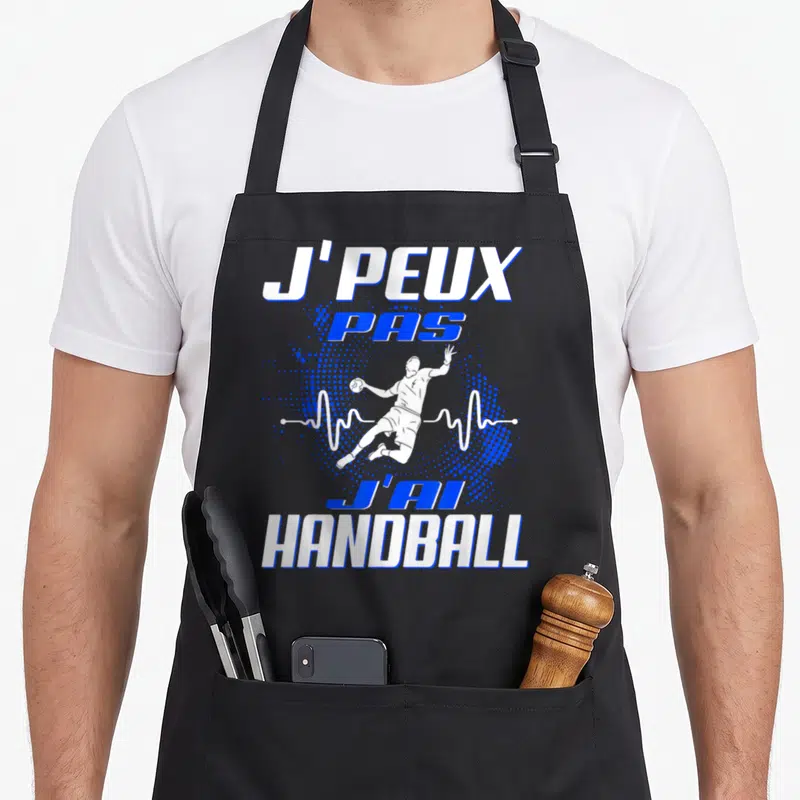 Tablier de cuisine noir avec illustration d'un joueur de handball et le texte j'peux pas j'ai handball enfant en blanc et bleu.
