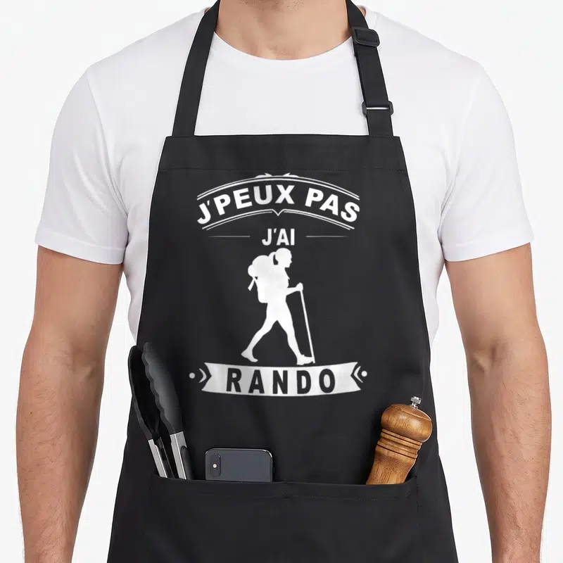 Tablier de cuisine noir avec silhouette blanche de randonneuse et texte j'peux pas j'ai rando