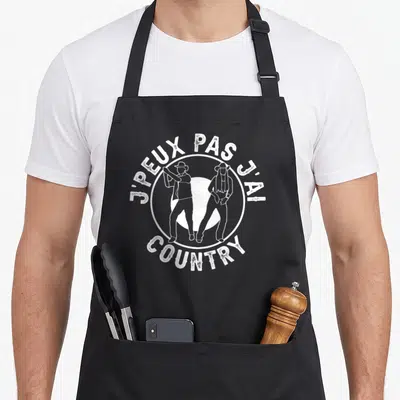 Tablier de cuisine noir avec inscription j'peux pas j'ai country cow-boy et deux silhouettes de danseurs en chapeaux.
