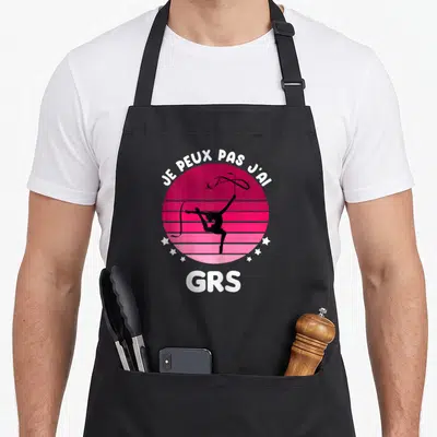 Tablier de cuisine noir avec motif gymnastique rythmique vintage et texte blanc sur fond rose strié