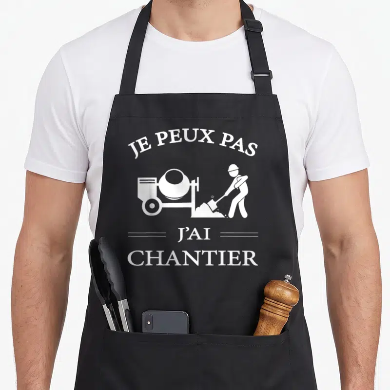 Tablier de cuisine noir avec inscription je peux pas j'ai chantier et silhouette ouvrier avec bétonnière.