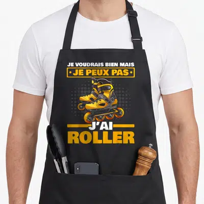 Tablier de cuisine noir avec illustration de patins à roulettes jaunes et texte je peux pas j'ai roller en orange et blanc.