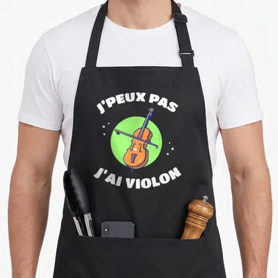 Tablier de cuisine noir avec illustration d'un violon orange sur fond vert et texte blanc.