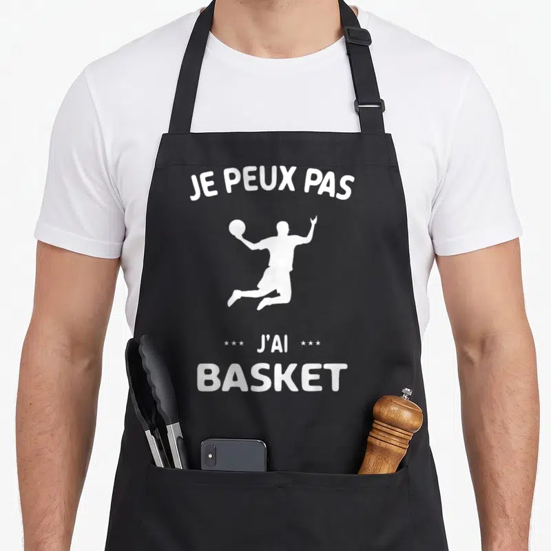 Tablier de cuisine noir avec silhouette blanche de joueur de basket et texte je peux pas j'ai basket