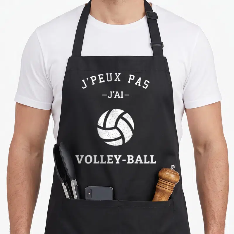 Tablier de cuisine noir avec illustration de balle de volley et texte blanc J'peux pas j'ai volley-ball