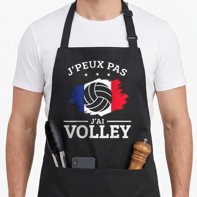 Tablier de cuisine noir avec motif tricolore, balle de volley et texte J'peux pas j'ai Volley en blanc.