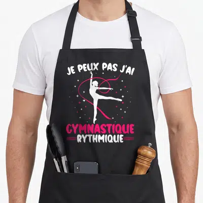Tablier de cuisine noir avec silhouette blanche de gymnaste et ruban rose vif.