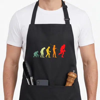 Tablier de cuisine noir avec silhouette évolutive d'un homme devenant joueur de rugby rouge