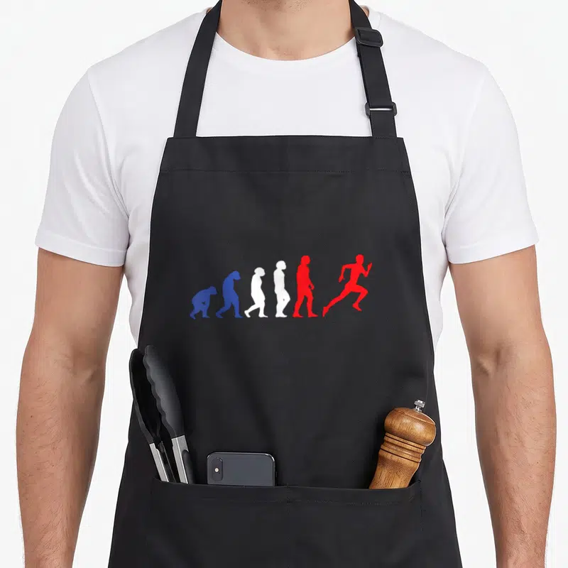 Tablier de cuisine noir avec illustration de l'évolution humaine se transformant en un sprinteur rouge dynamique.