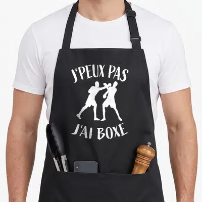 Tablier de cuisine noir avec silhouette de deux boxeurs et texte blanc J'peux pas j'ai boxe