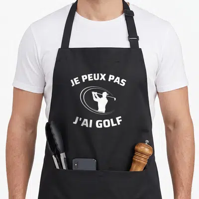 Tablier de cuisine noir avec inscription blanche Je peux pas j'ai golf et silhouette de joueur de golf.